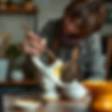 An artist applying glaze to a ceramic sculpture