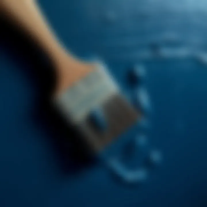 A brush applying dark blue paint on canvas