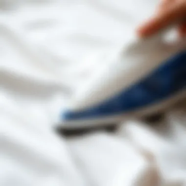 Close-up of a steaming iron on a satin fabric