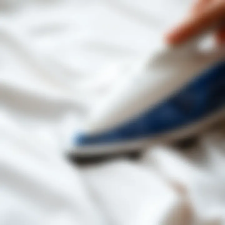 Close-up of a steaming iron on a satin fabric